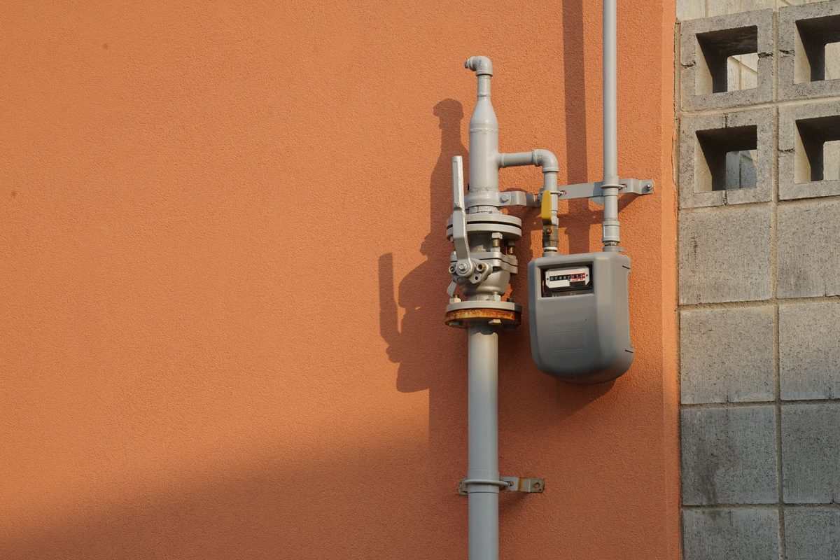 Gas meter, regulator and service riser on an exterior wall