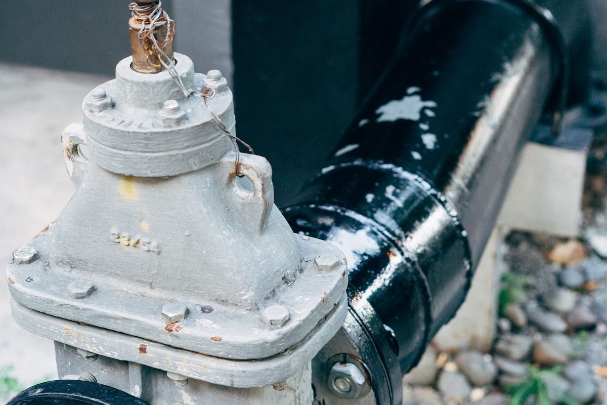 Hand valve on a large black pipe